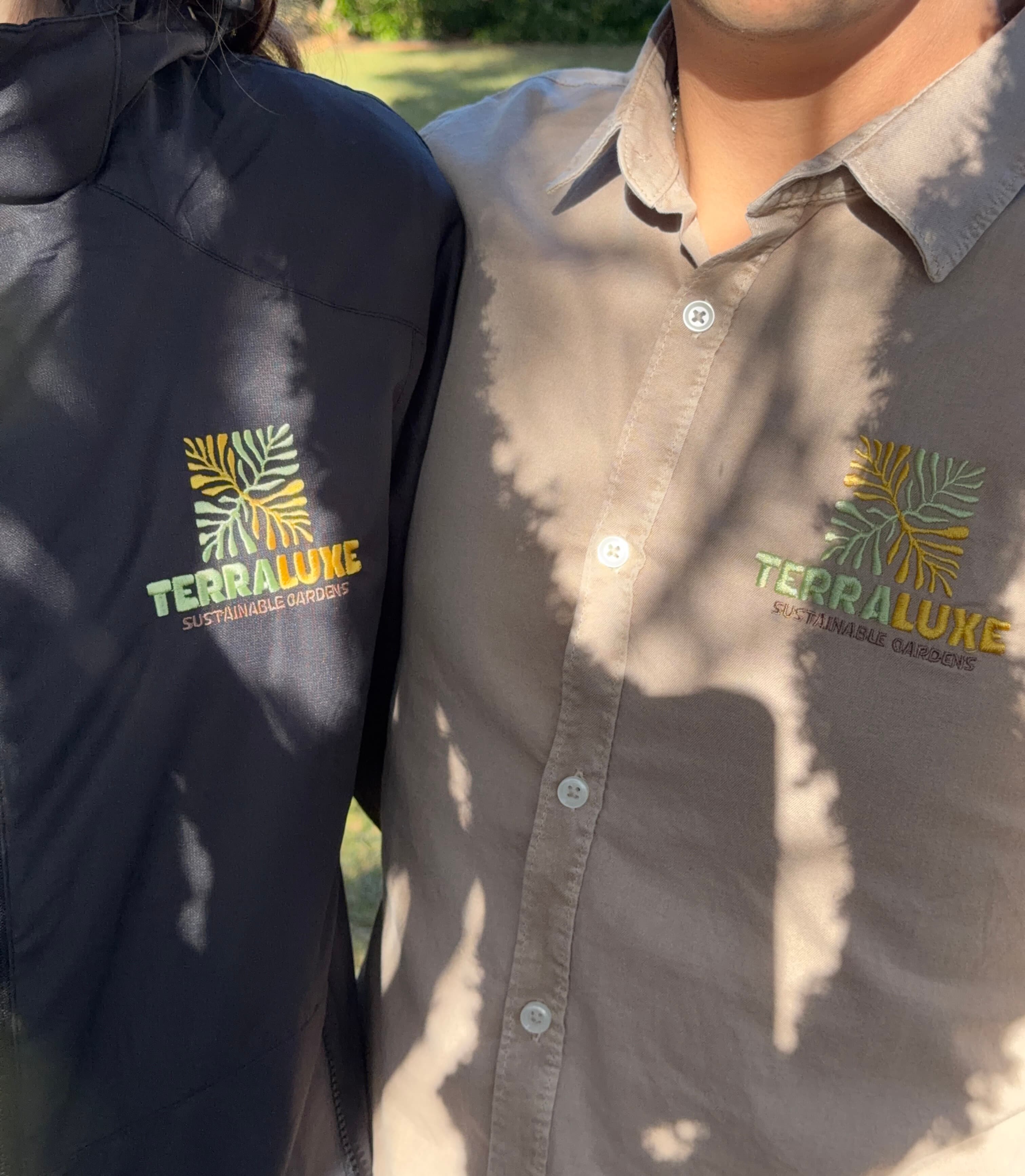 TerraLuxe Gardens team wearing embroidered uniforms in a Mediterranean garden in Mallorca