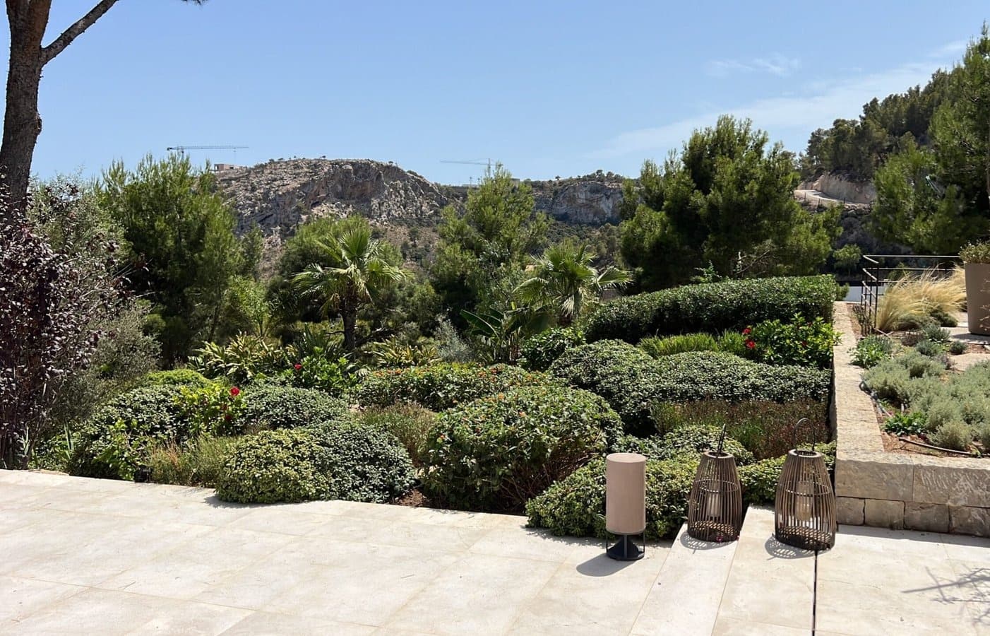 Mediterranean garden with clipped boxball topiary and Mallorcan sierra beyond